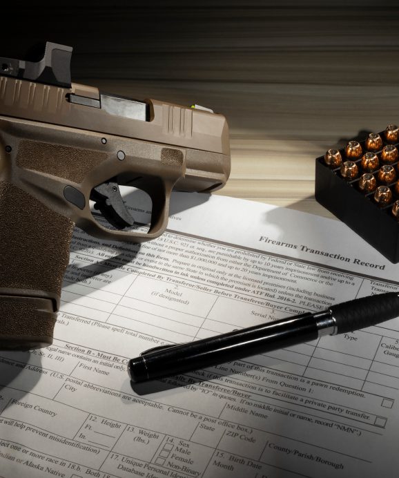 Gun, bullets, pen, and transaction record form.