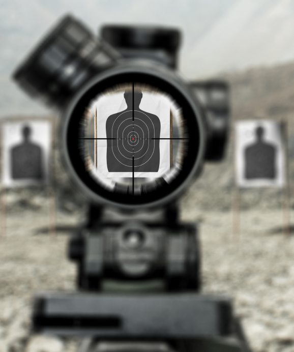 Target in rifle scope at shooting range.
