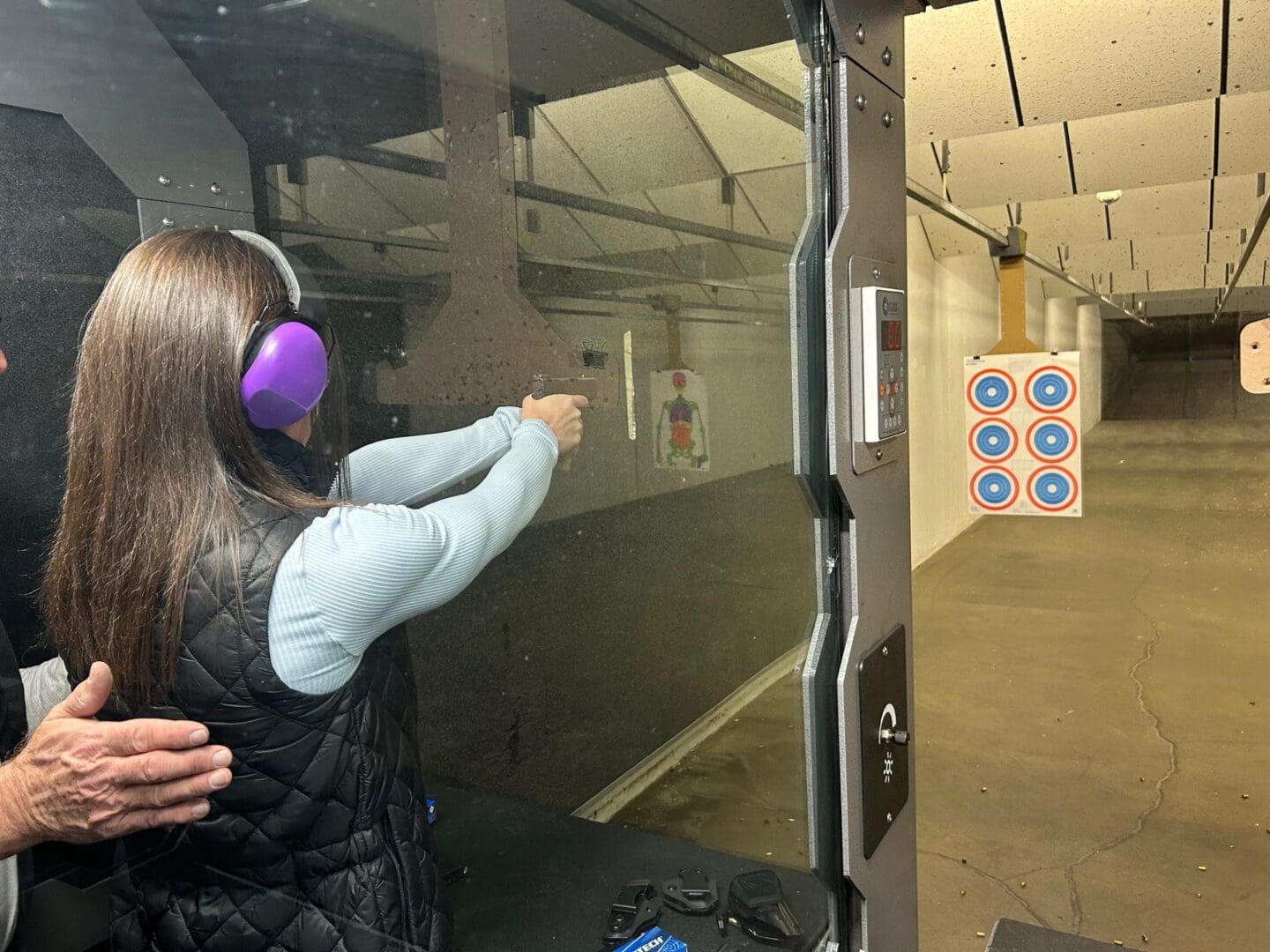 Person aiming at target in shooting range.