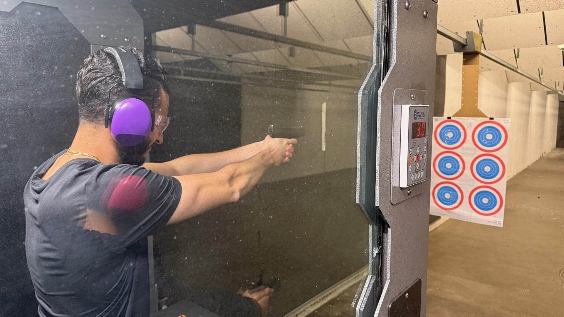 Person shooting at a target in range.