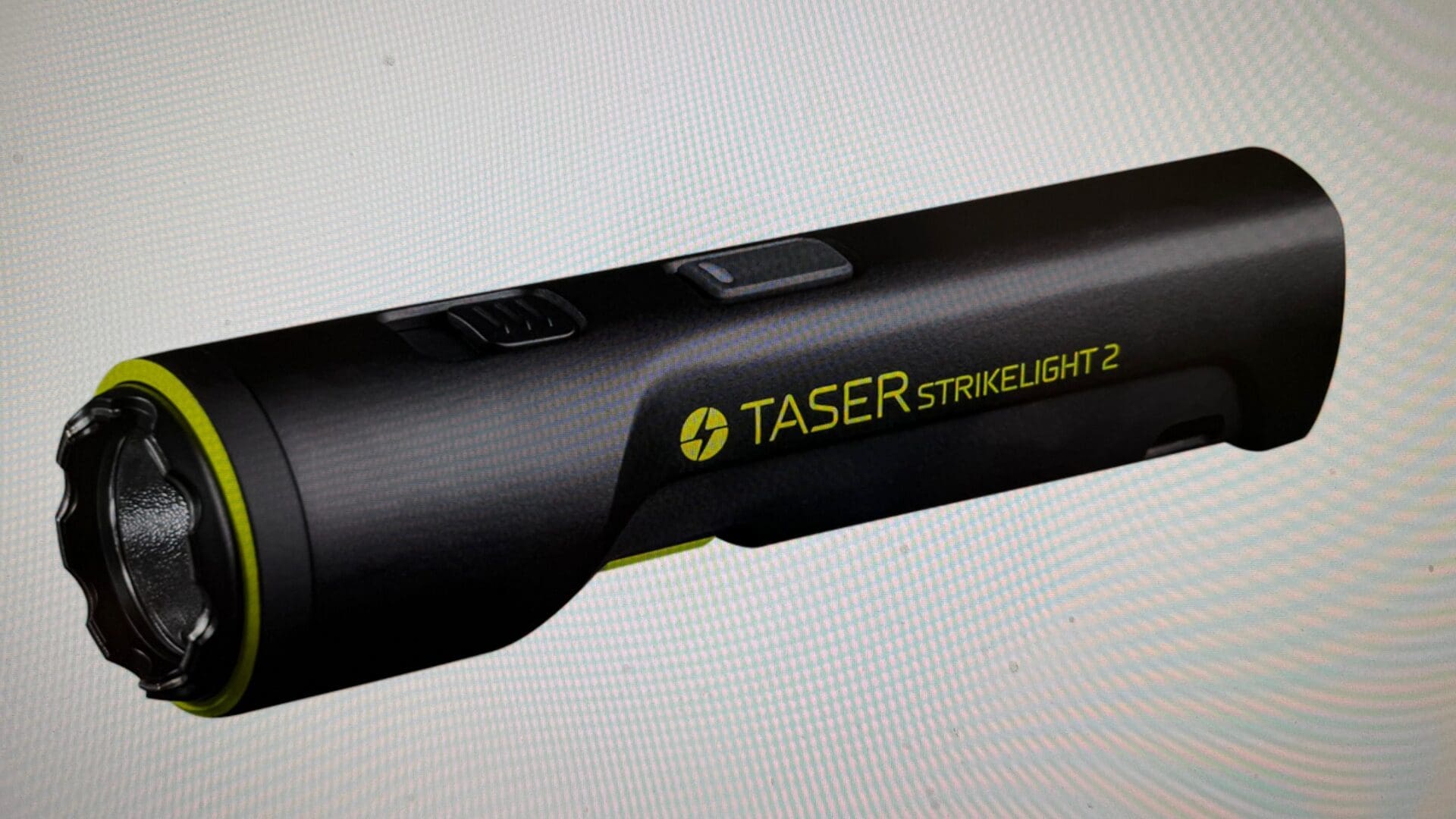 Black TASER flashlight with green accents.